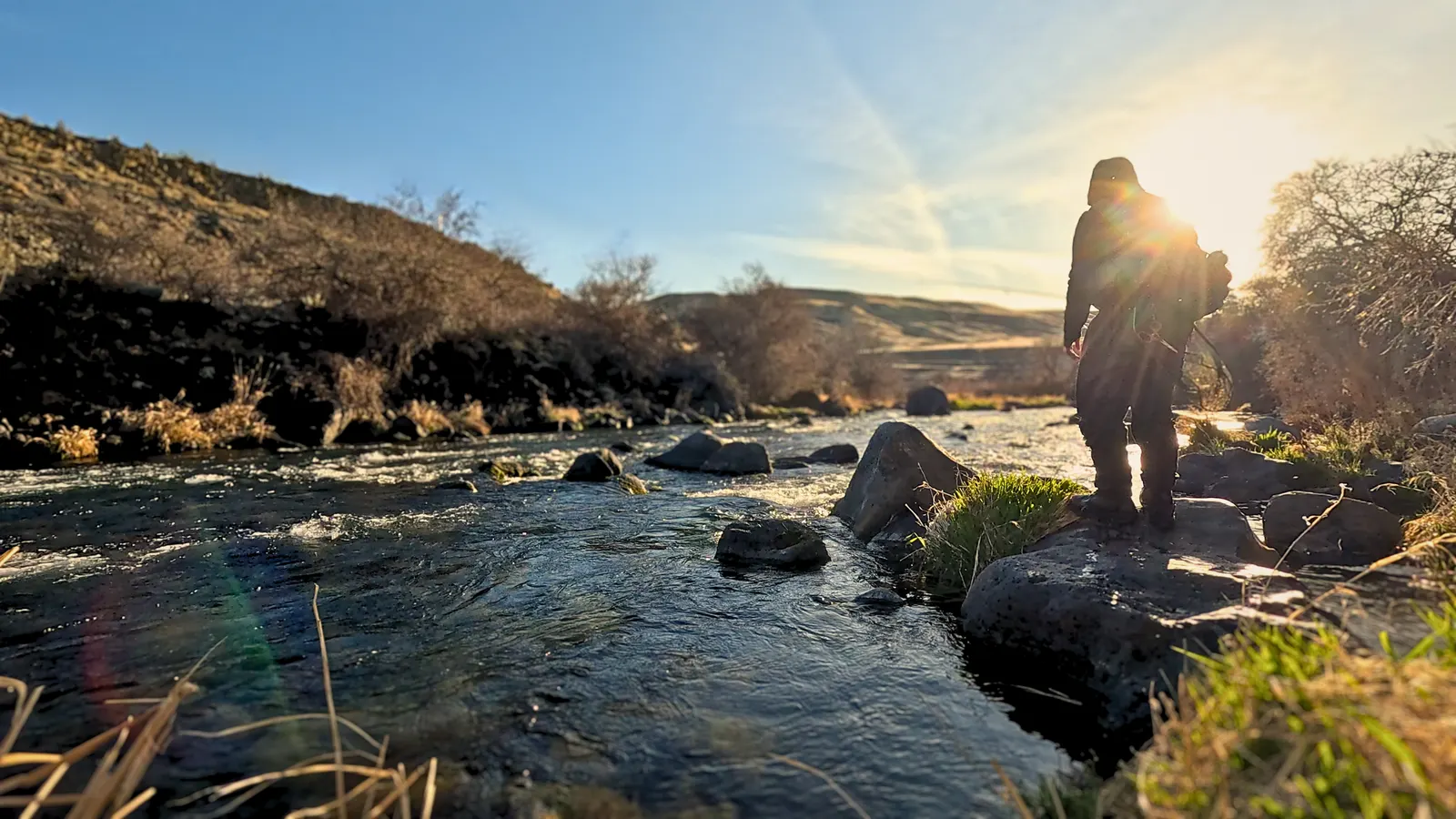 Derrick fishing a river at sunrise